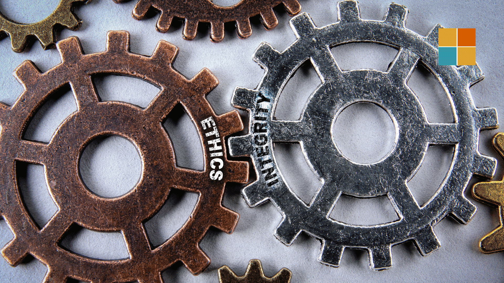 Interlocking gears labelled ethics and integrity symbolising values.